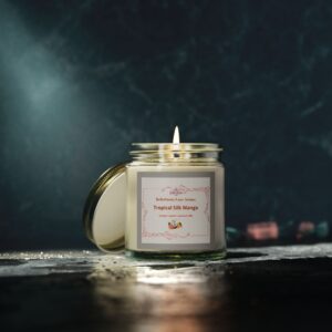 A hand-poured Tropical Silk Mango scented candle in an amber or clear glass jar with a gold lid, featuring coconut apricot wax and a soft clean-burning flame